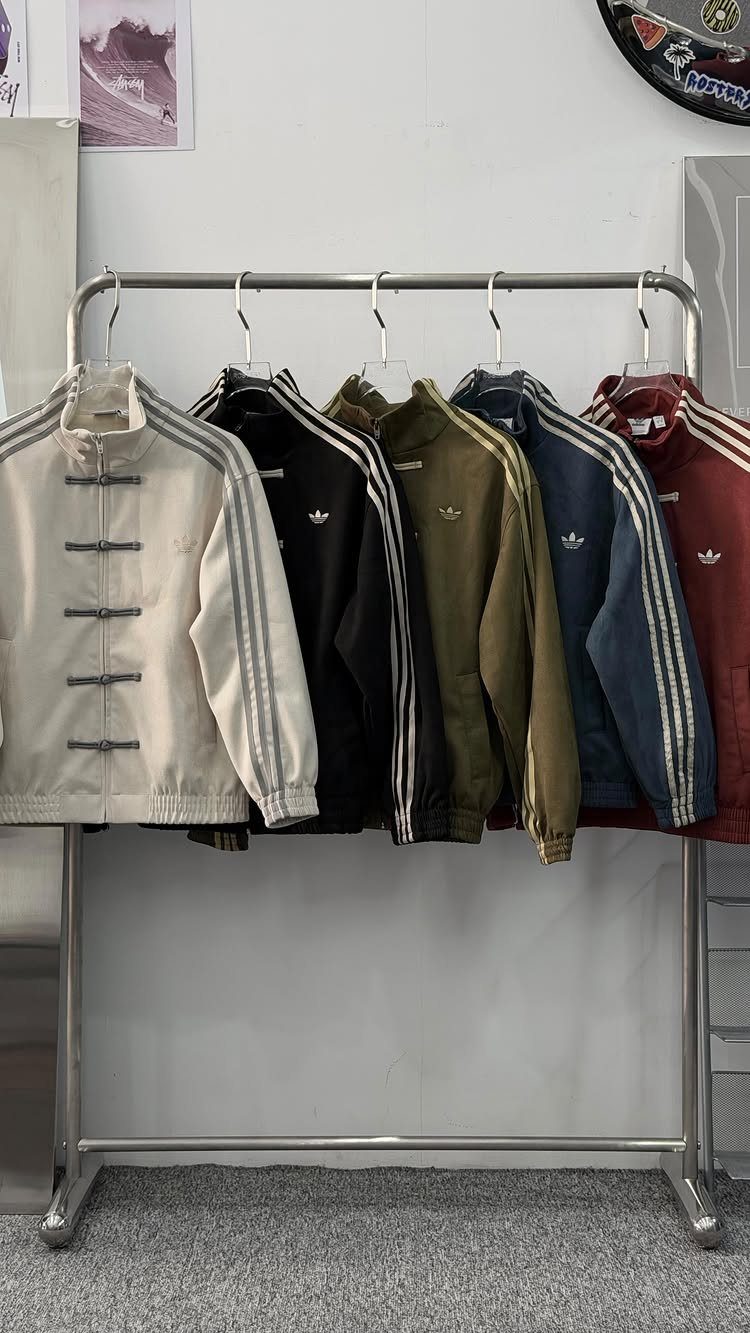 Adidas jackets with traditional Chinese frog buttons and mandarin collars on a rack