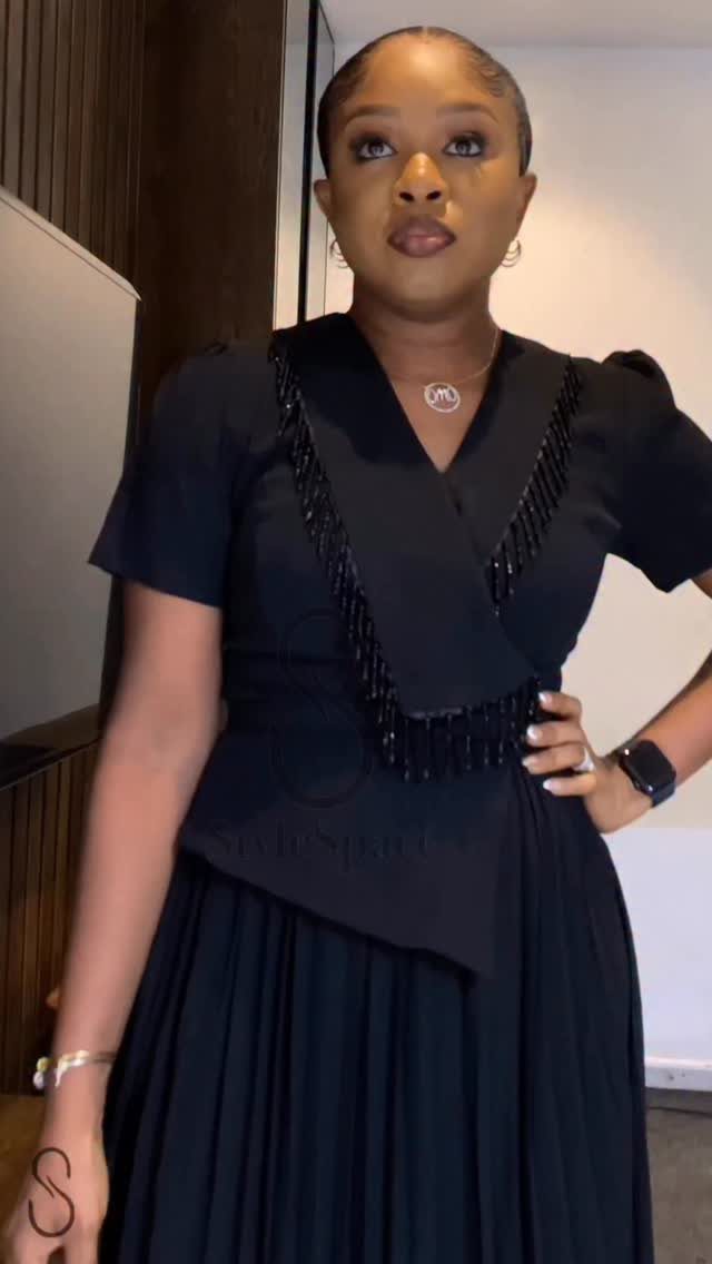 8 Beaded Formal Dress Ideas for Every Color and Style 1 Woman wearing a black formal dress with black beaded neckline and waist details.
