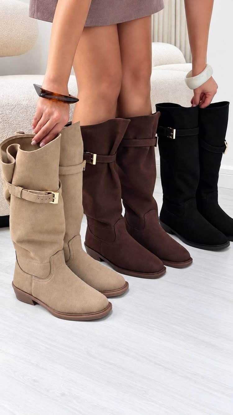 Mid-calf suede boots in beige, brown, and black with decorative ankle buckles.