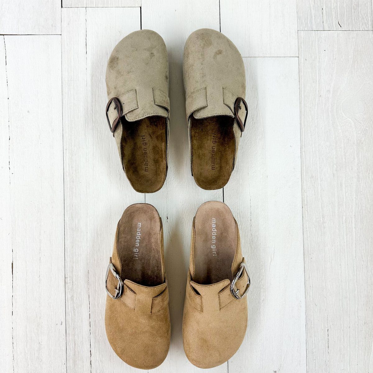 Two pairs of Madden Girl suede clogs in grey and tan on white flooring
