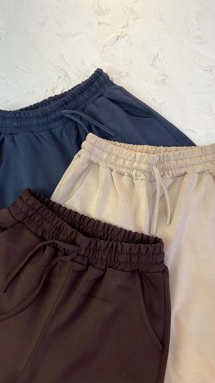 Clothing and Shoes: 8 Ideas for Everyday Outfits 4 Three pairs of drawstring sweatpants in navy, beige, and brown on white background.