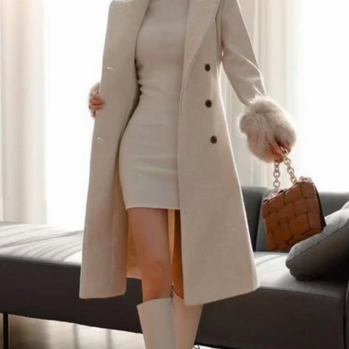 9 Dress and Coat Outfit Ideas for Work, Evenings and More 5 Woman in cream knit dress and long cream coat holding brown woven handbag