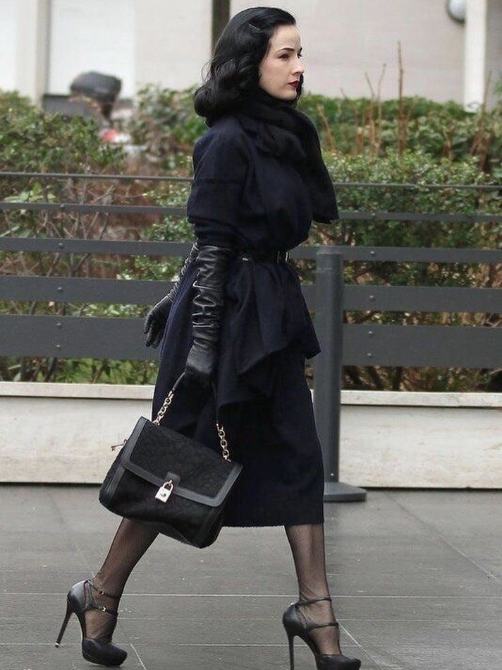 Femme Fatale 1940s Style: 5 Ideas from Film Noir 3 Woman in vintage black coat and leather gloves walking outdoors in 1940s style.
