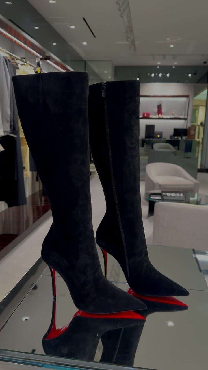 High Heels Design Ideas: 9 Styles from Slingbacks to Platforms 7 Black suede knee-high boots with red soles and stiletto heels on glass.