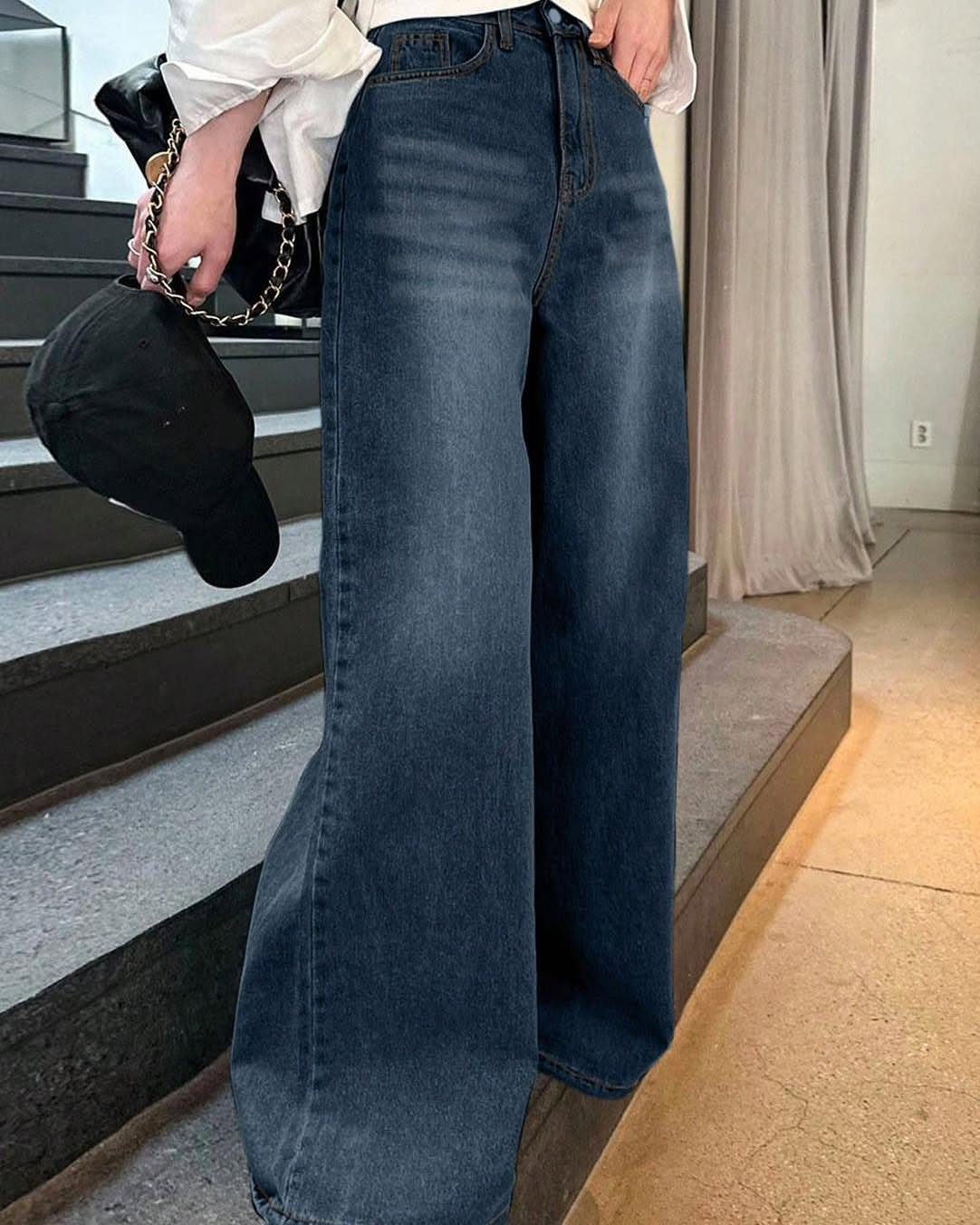 Wide-leg high-waisted blue jeans paired with a white top and black accessories.