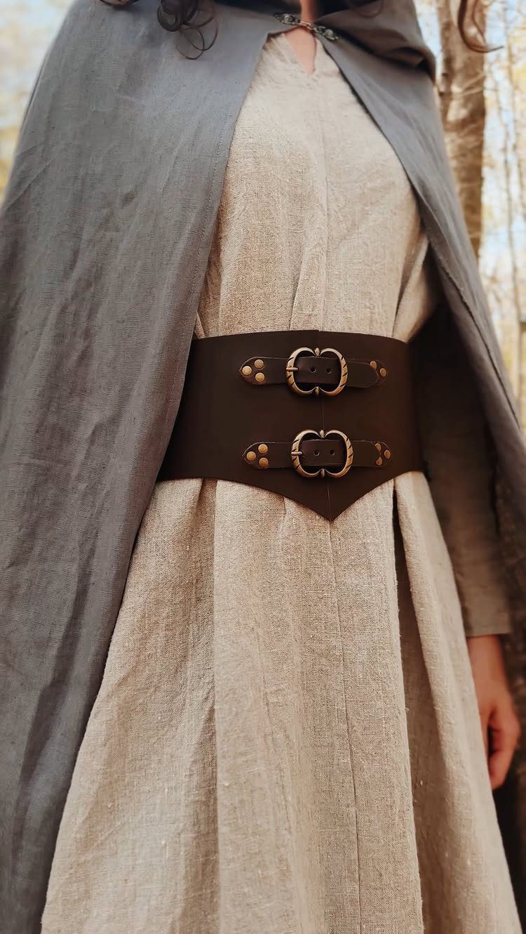 Beige linen medieval dress with a wide brown leather corset belt and grey cloak
