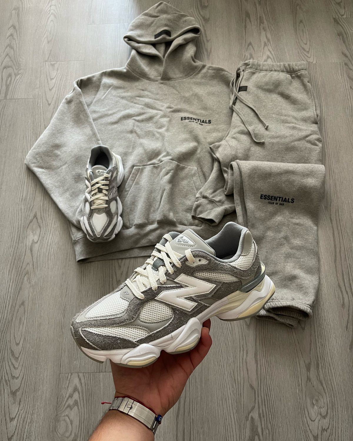 New Balance 9060 All Colors: 8 Pairs to Consider 1 White and grey New Balance 9060 sneakers paired with a grey Essentials tracksuit.