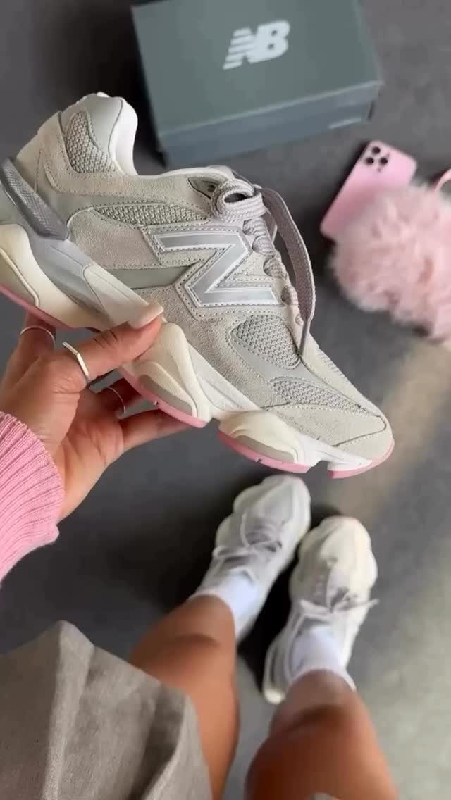 White and grey New Balance 9060 sneakers with a chunky sculpted sole design.