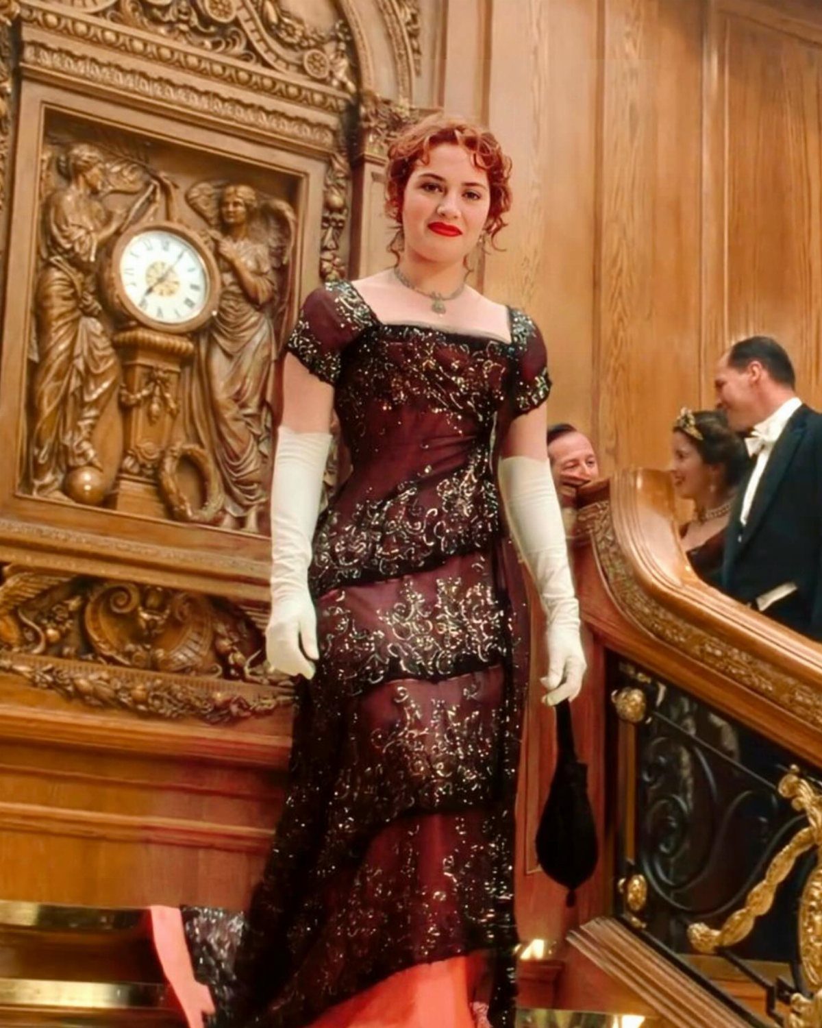 Woman in a burgundy sequined vintage gown and white gloves in ornate room