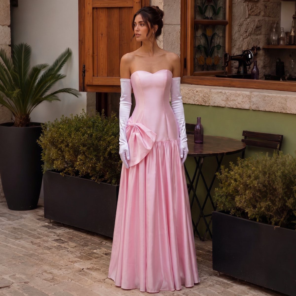 Woman in a strapless pink satin hourglass gown with white opera gloves.