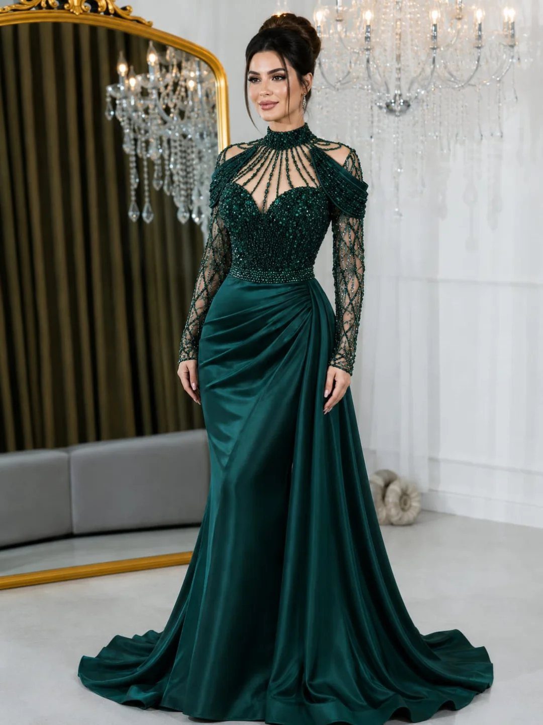 Woman in a beaded emerald green satin gown standing in a luxury room