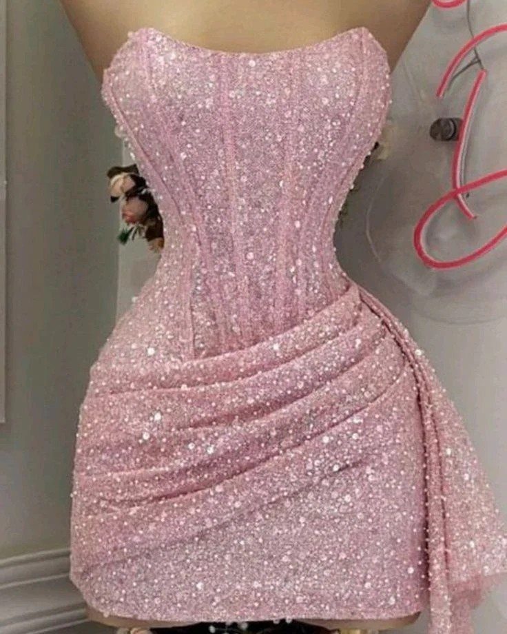 Light pink sequined mini dress with a corset bodice and ruched skirt.