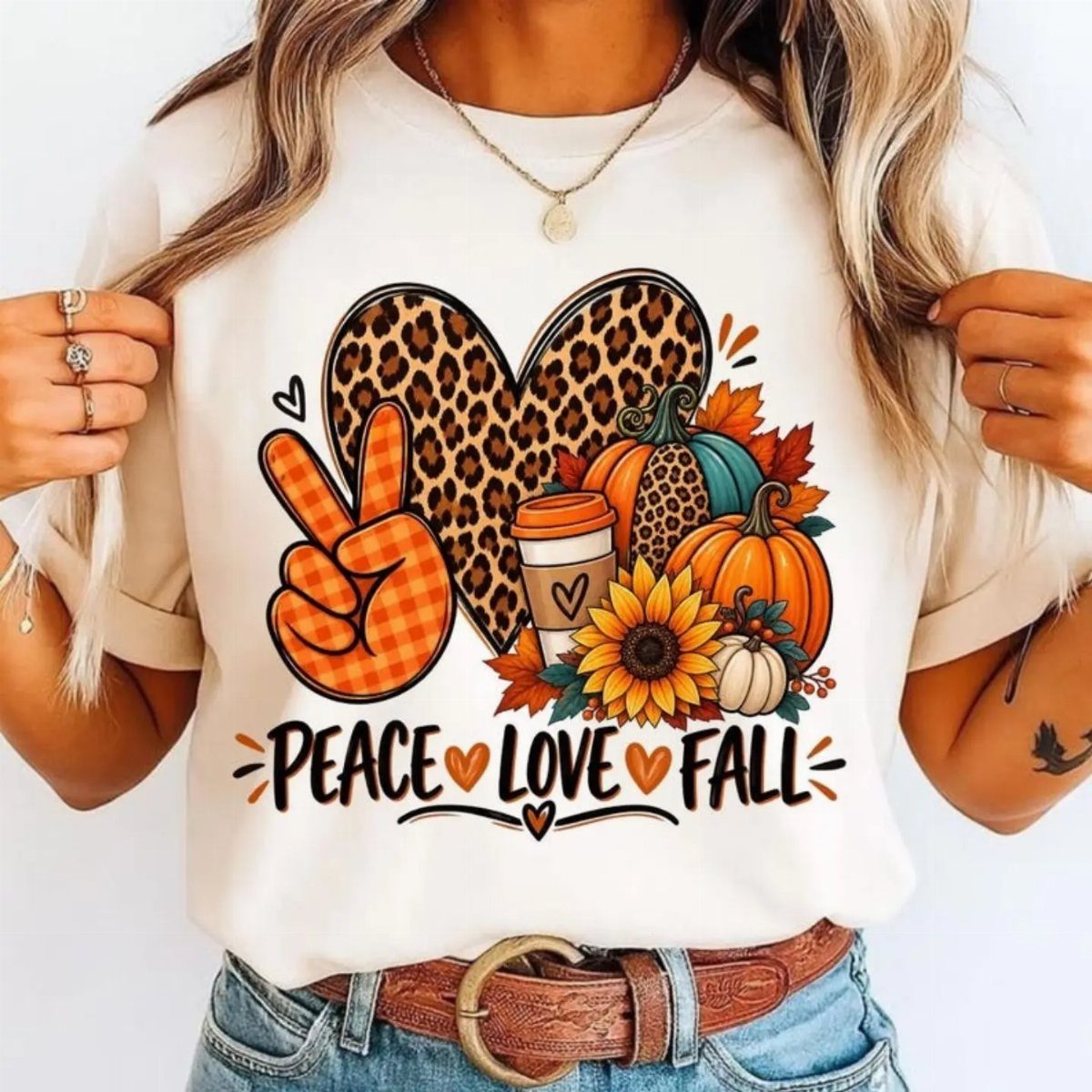 Cream t-shirt with leopard print heart and fall pumpkins graphic on a person