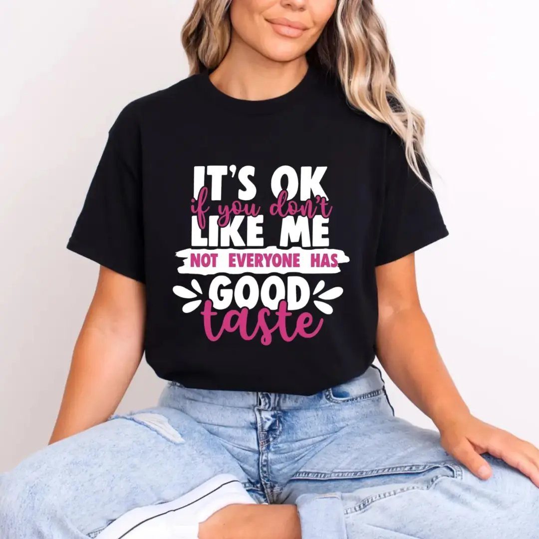 Woman wearing a black graphic tee with a humorous quote about good taste.