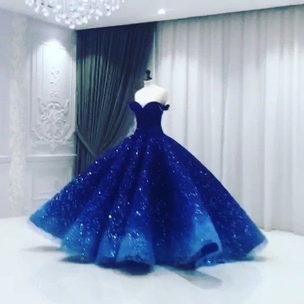 Royal blue glitter ball gown on a mannequin in a bright room