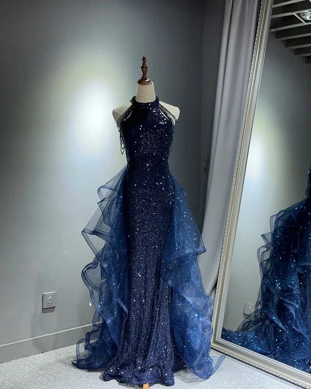 Royal blue sparkling gown with ruffled tulle overskirt displayed on a mannequin
