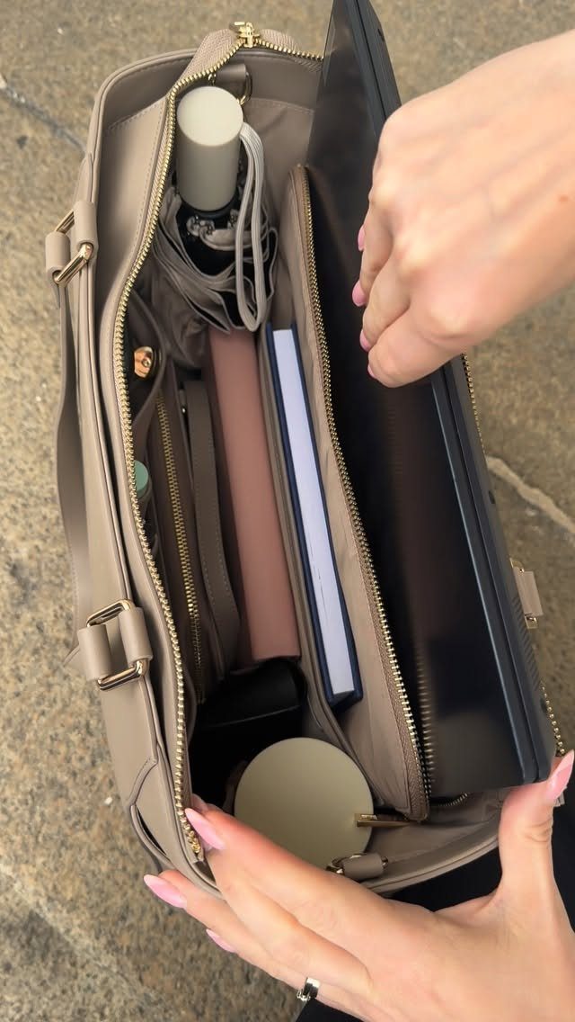 Beige tote bag open showing a laptop, notebooks, and water bottle inside.