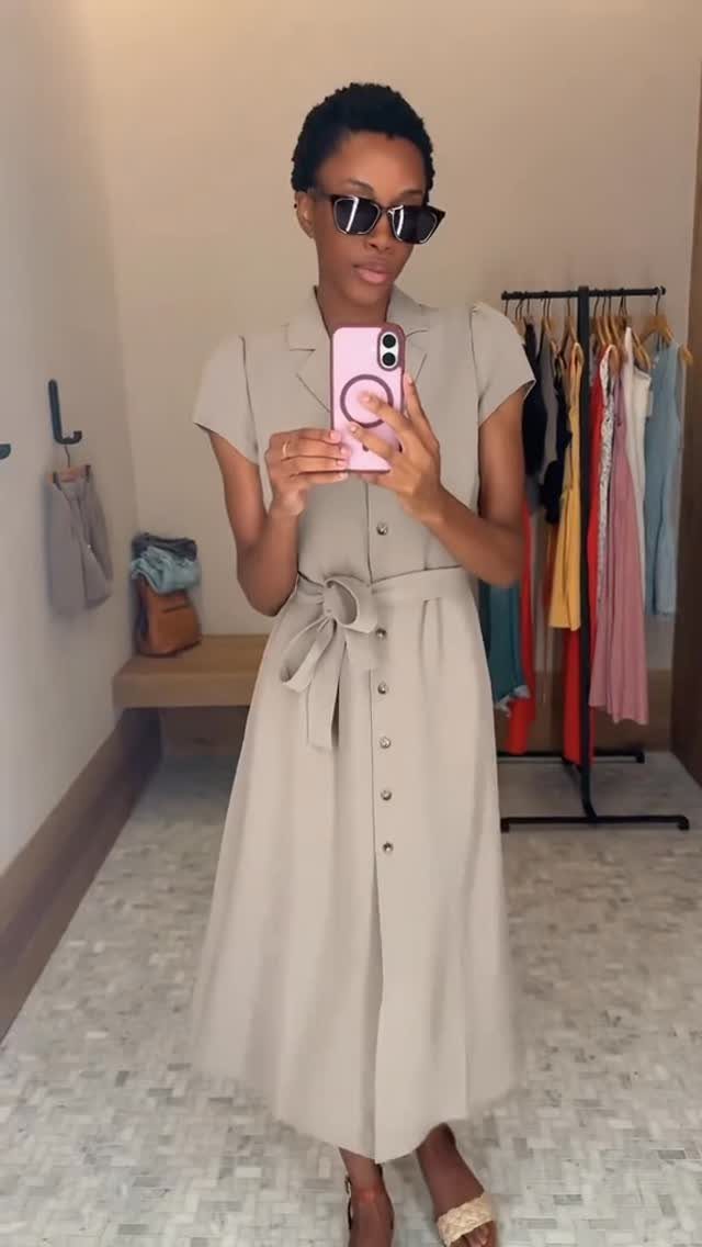 Woman wearing a beige button-down midi shirt dress with a tie-waist belt.